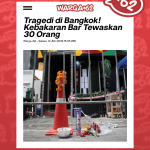 Street memorial scene: orange garland on a traffic cone behind metal barricades, with flowers, candles, and a bottle on the ground after a tragedy in Bangkok (news photo).